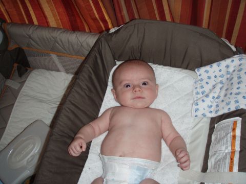 1997 Ford F-250 - A baby lies in a crib, looking up with a curious expression.