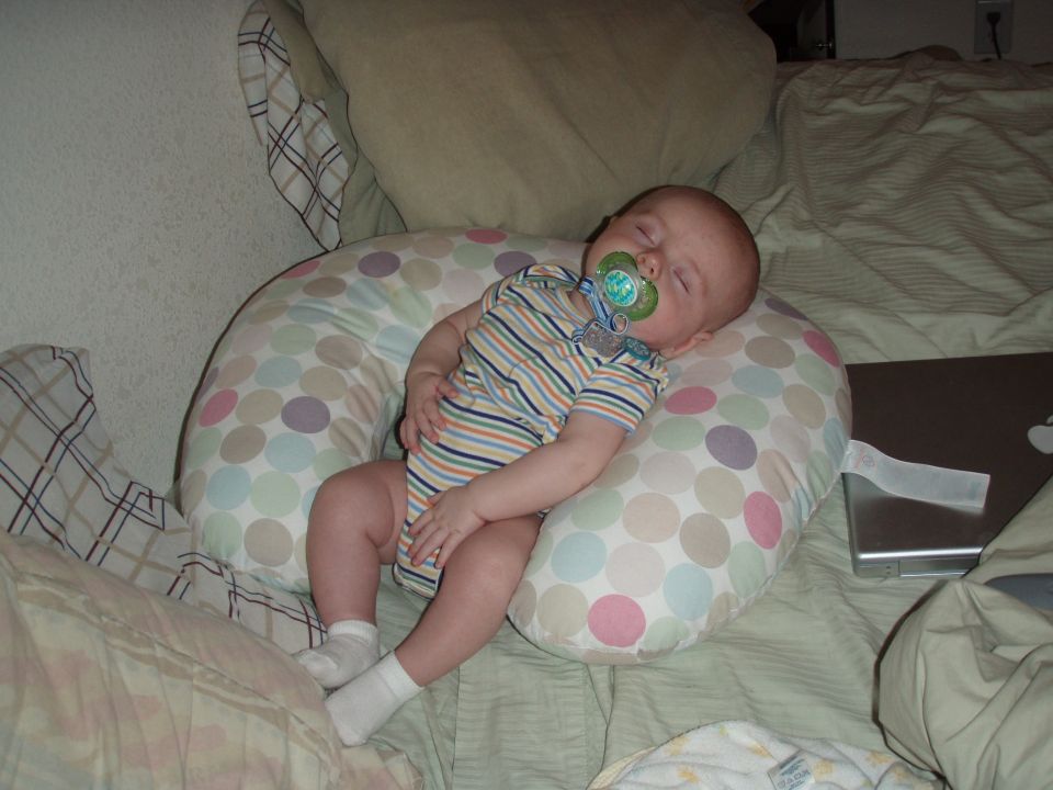 Baby sleeping on a nursing pillow