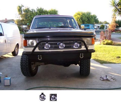 1991 Ford Bronco - Custom front bumper fabrication is visible on this dark-colored SUV.