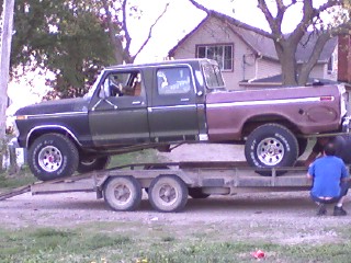 1979 Ford Bronco - A two-tone Ford F-Series pickup truck, likely from the late 1970s or early 1980s, is loaded onto a trailer.
