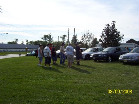 2008 Ford Crown Victoria - A group of people stand around several cars on a sunny day, with a date stamp indicating August 9, 2008.