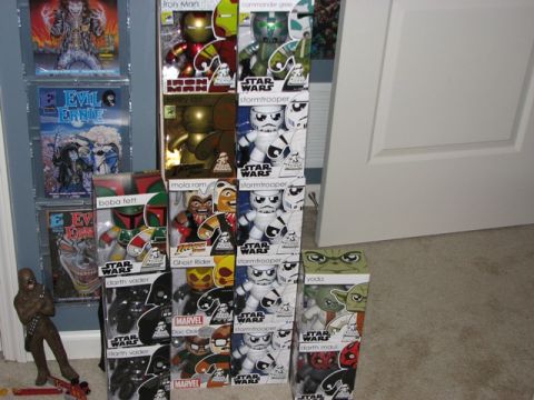 1991 Ford Bronco - A collection of Star Wars and Marvel action figures are displayed next to comic books on a wall.