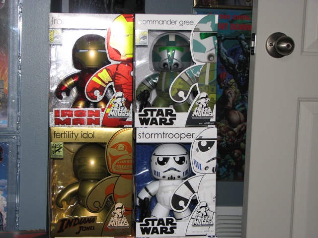 Four boxed toys: Iron Man, Commander Gree, Fertility Idol, and Stormtrooper
