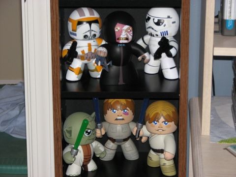 1991 Ford Bronco - A collection of Star Wars action figures are displayed on a shelf in a room.