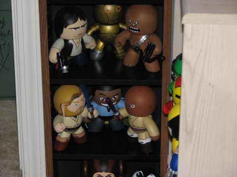 1991 Ford Bronco - A collection of Star Wars action figures are displayed on shelves, with some figures holding lightsabers and blasters.