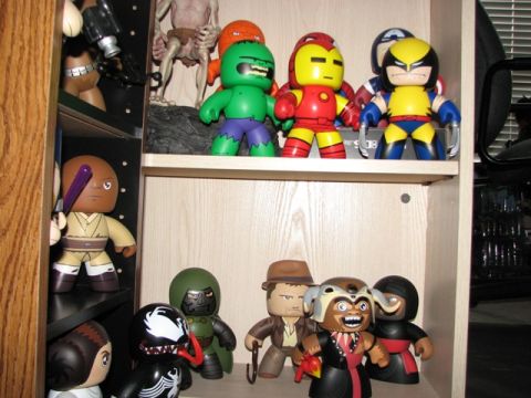 1991 Ford Bronco - A collection of popular culture action figures are displayed on shelves in-home shelving units.