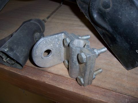1991 Ford Bronco - Close-up of a metal bracket and associated hardware, likely a vehicle part.