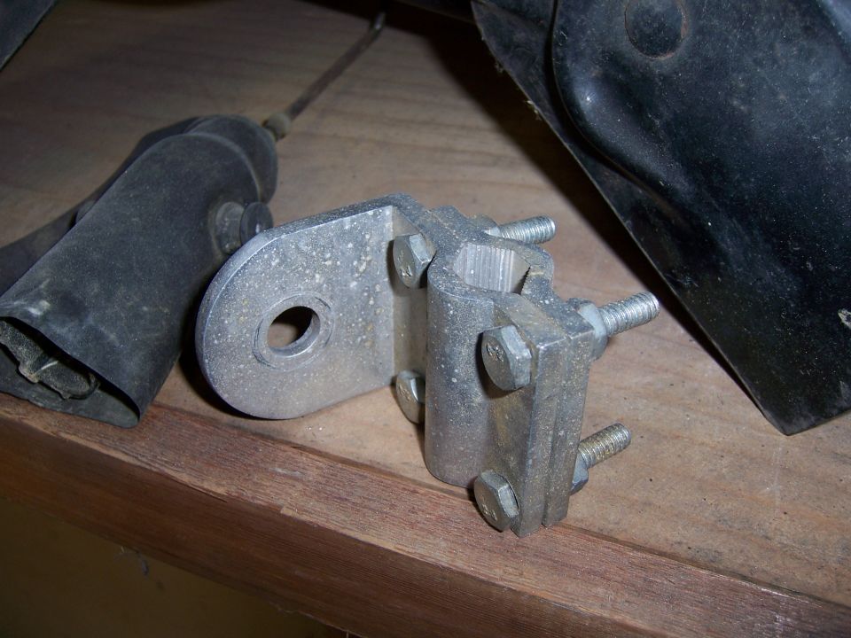 Metal bracket assembly with bolts and a black rubber component