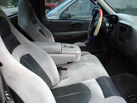 2007 Ford Mustang - Interior of a truck showing front seats, dashboard, and steering wheel.