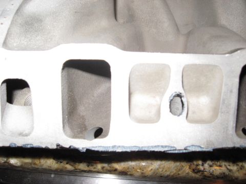 1991 Ford Bronco - This is a close-up view of an engine intake manifold, showing its internal structure and ports.