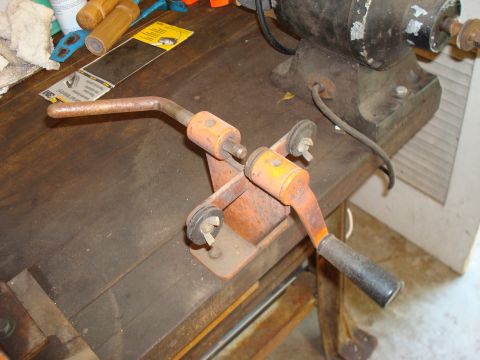 1992 Ford Bronco - Workbench with a metal tool and a motor in the background.