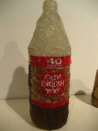 1992 Ford Bronco - This photo shows a bottle decorated with broken glass pieces, an 'Olde English 800' label.