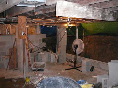 1997 Mercury Grand Marquis - The image shows a cluttered house foundation area with construction materials and electrical wiring visible.