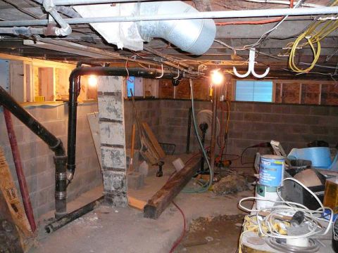1997 Mercury Grand Marquis - This is a view of a basement with exposed pipes, wiring, and unfinished walls, along with various building materials and tools.
