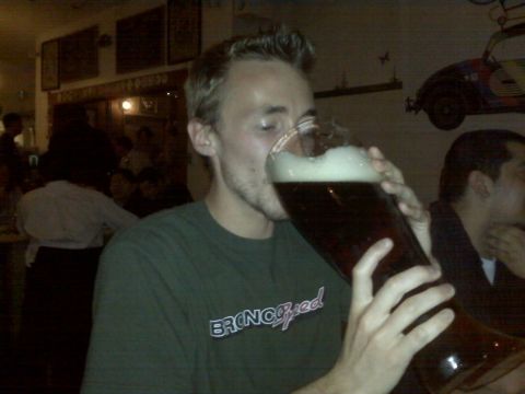 1996 Ford Bronco - A man drinks a large beer in a dimly lit establishment.