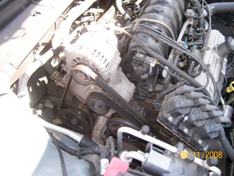 1995 Mercury Grand Marquis - Close-up view of an engine bay, showing various mechanical components and wiring.
