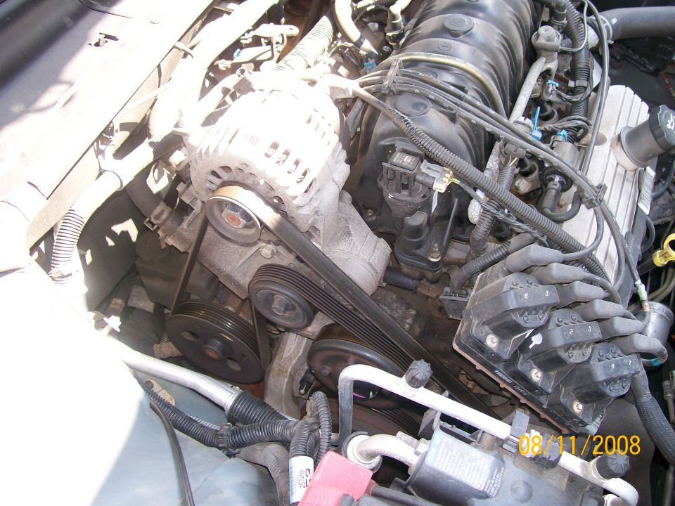 Engine bay with alternator, belts, and spark plug wires visible. Date stamp reads 08/11/2008