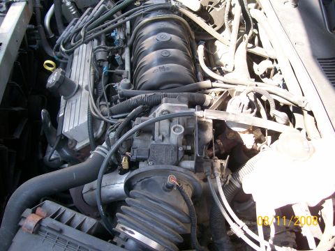 1995 Mercury Grand Marquis - Close-up view of a vehicle's engine bay, showing various hoses, wires, and engine components. The image includes a date stamp from 2008.