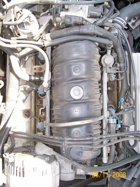 1995 Mercury Grand Marquis - This image shows a detailed view of an engine bay with various components and wiring harnesses visible.