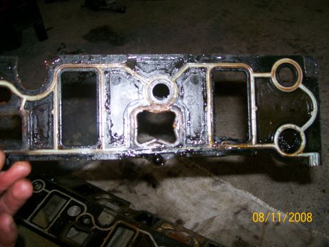 1995 Mercury Grand Marquis - A used intake manifold gasket, likely from an older vehicle, shows signs of wear and oil contamination.