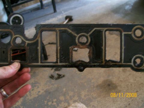 1995 Mercury Grand Marquis - Close-up of a used intake manifold gasket, showing wear and tear.