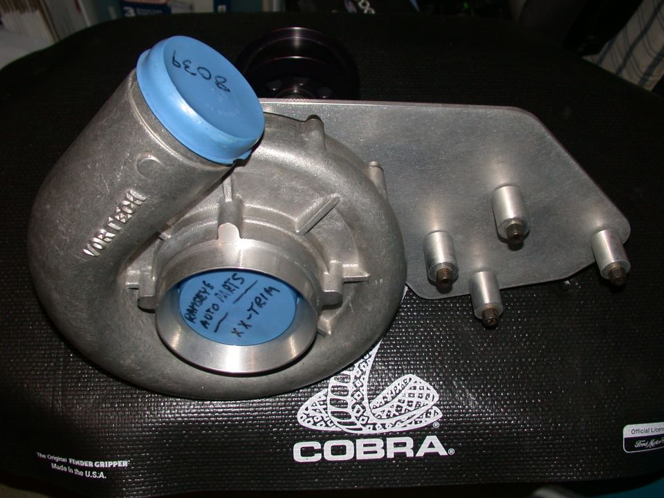 Vortech supercharger with blue caps and pulley on Cobra fender mat