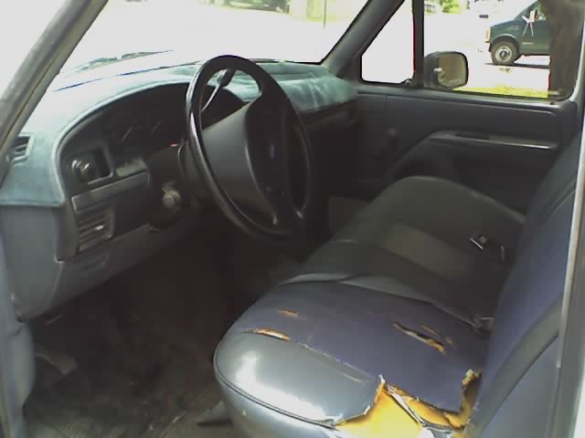 Interior view of a 1992 Ford F-150 pickup truck, showing the driver's seat and dashboard.