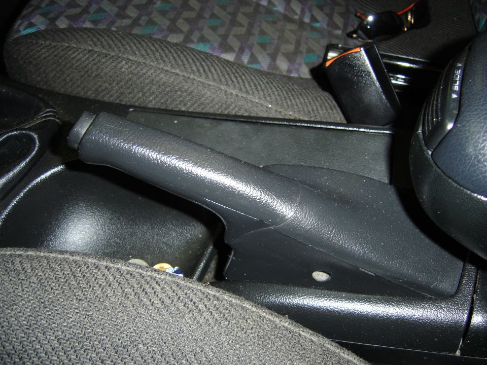 Close-up of a car's handbrake lever and center console.