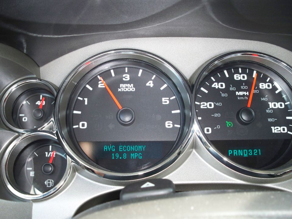 Vehicle dashboard showing speedometer, tachometer, and fuel gauge.