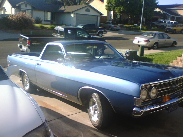Blue and silver Ford Ranchero parked in a driveway