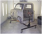 2007 Ford Mustang - Photograph of a primed truck cab in a paint booth, not a technical document.