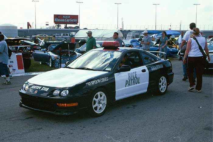 Black and white Acura Integra police-replica "Rice Patrol" car with roof light bar