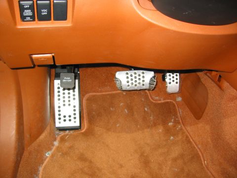2002 Nissan Altima - Interior view of a car's footwell, showing the pedals and lower dashboard area.