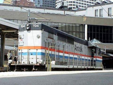 1992 Ford Bronco - An Amtrak locomotive, number 194, is parked at a station with modern buildings in the background.