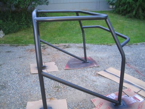 1989 Ford Bronco - Newly painted roll cage, likely for an off-road vehicle, drying outdoors.