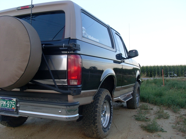 1996 Ford Bronco parked on dirt road, spare tire mounted on rear door