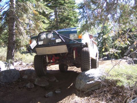 1991 Ford Bronco - This modified 1992 Ford Bronco navigates a rocky trail in a wooded area.