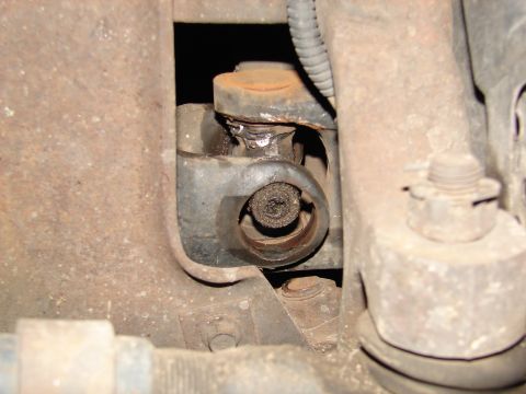 1996 Ford Bronco - This image shows a close-up view of a worn and rusty suspension component, likely from a vehicle's undercarriage.