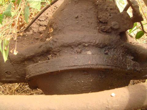 1992 Ford Bronco - A heavily soiled differential housing is shown, obscuring any identifying marks or vehicle details.