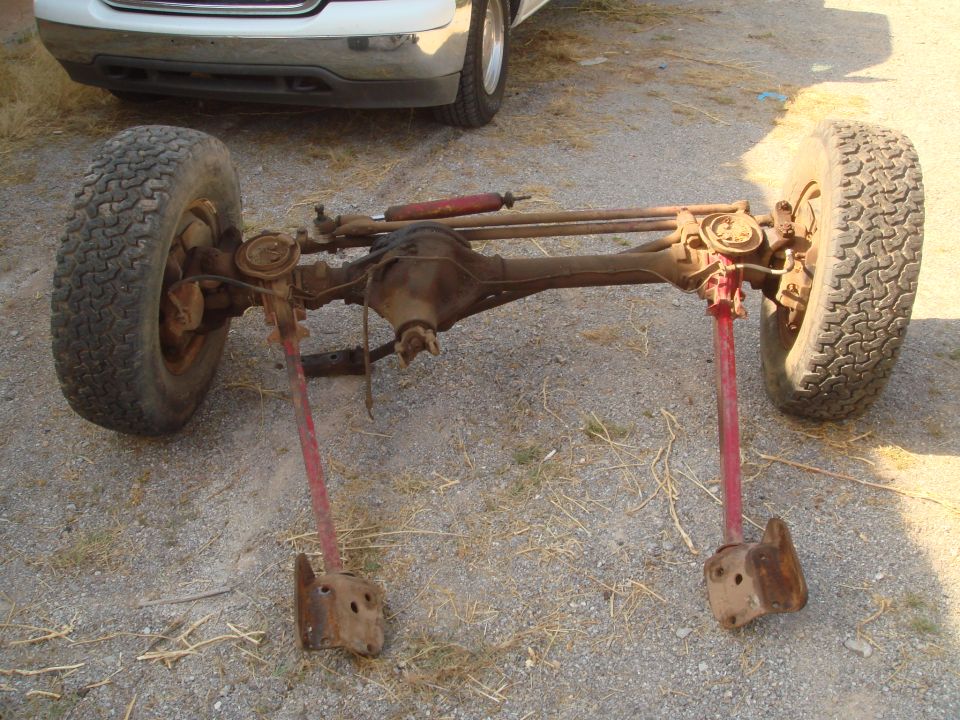Front axle assembly with tires and red shock absorber