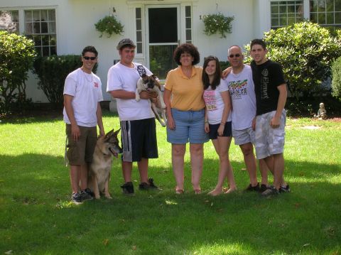 1996 Ford Bronco - A family and their dogs are gathered on the grass in front of a suburban home.
