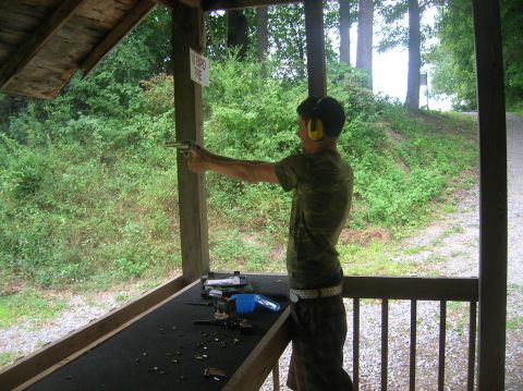 1996 Ford Bronco - Shooting practice at an outdoor range with firearms and spent casings visible on the table.