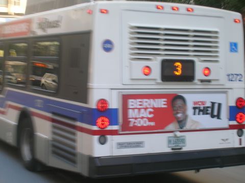 1996 Ford Bronco - The back of a public transit bus shows its route number and an advertisement.