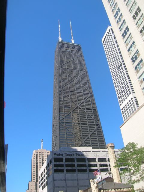 1996 Ford Bronco - The John Hancock Center, a prominent skyscraper, stands tall against a bright blue sky, with the Water Tower Place building visible at its…