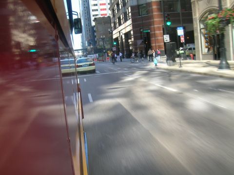 1996 Ford Bronco - View from inside a red vehicle looking out at a city street with a yellow taxi and pedestrians.