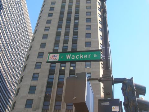 1996 Ford Bronco - A street sign for E Wacker Dr is visible against a backdrop of tall buildings and a clear blue sky.