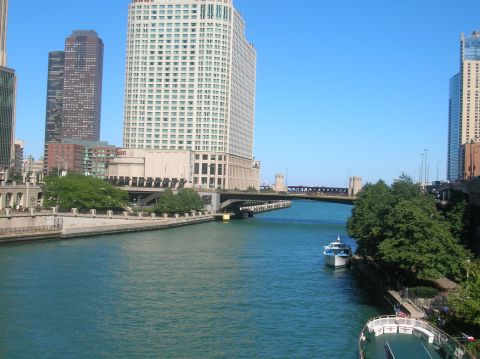 1996 Ford Bronco - Boats are docked along the Chicago River, with tall buildings and a bridge visible in the background.