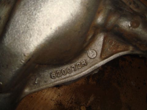 1992 Ford Bronco - A metal component displays casting numbers, indicating its origin or part identification.