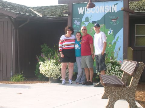 1996 Ford Bronco - A family visits a Wisconsin welcome center, posing for a photo in front of a large map of the state.