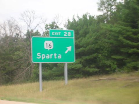 1996 Ford Bronco - A green highway sign indicates exit 28 and route 16 towards Sparta, with trees in the background.